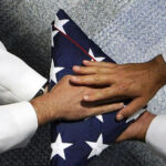 Funeral Services - photo of hands on a folded flag